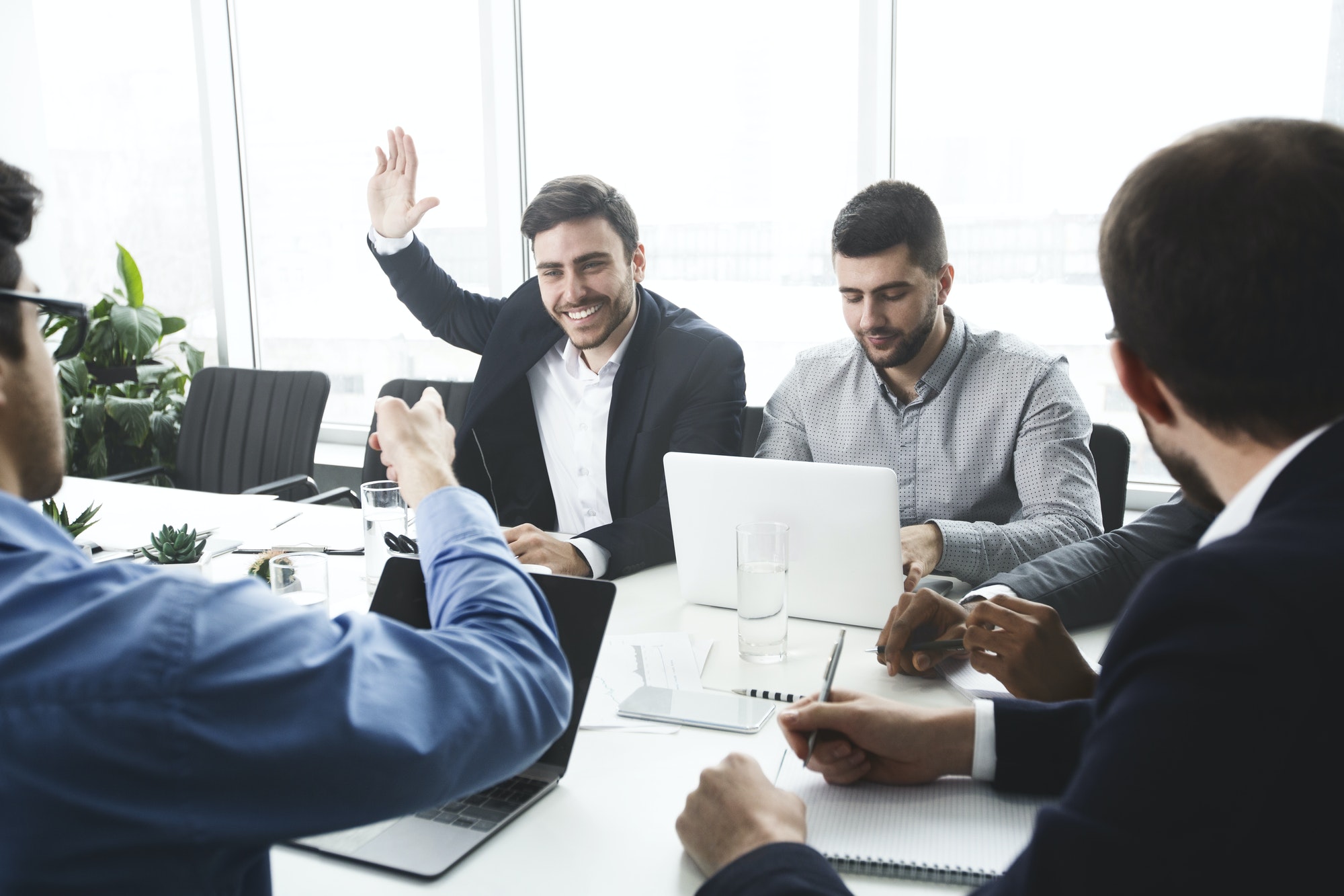 businessman-raising-hand-and-asking-question-at-meeting.jpg